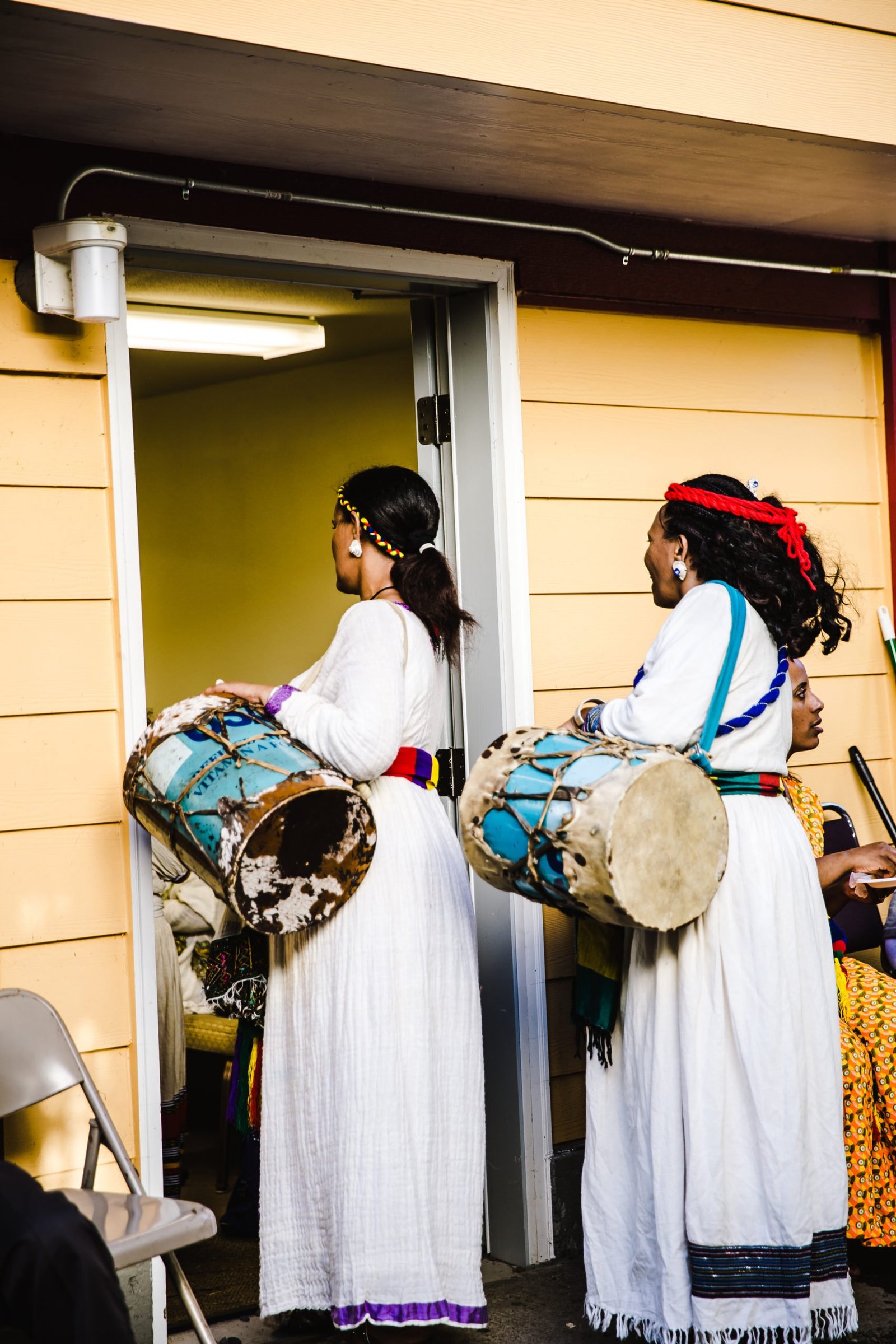 storyblocks-ethiopian-women-holding-drums-with-shoulder-strap_S2p8VhiFP-scaled.jpg