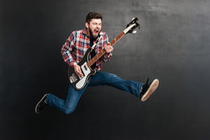 graphicstock-photo-of-screaming-man-dressed-in-shirt-in-a-cage-jumping-over-chalkboard-while-playing-on-the-guitar-music-concept_BITP7d7dng_thumb.jpg
