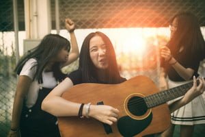 storyblocks-group-of-asian-teenager-standing-outdoor-plying-spanish-guitar-and-dancing-with-happiness-emotion_B6qOuuDtE_thumb.jpg