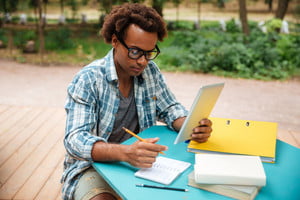 graphicstock-serious-african-young-man-writing-and-learning-in-the-park_HOfqxMhr3l_thumb.jpg