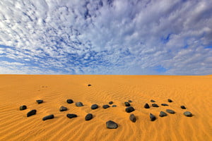 storyblocks-yellow-sand-summer-dry-landscape-in-africa-black-pebble-stone_S9lW21mQbf_thumb-1.jpg