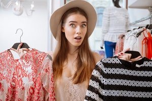 graphicstock-confused-cute-woman-doing-shopping-and-choosing-dress-in-clothing-store_SdmvXpzB2e_thumb.jpg