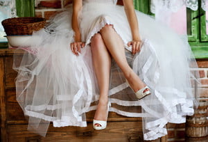 graphicstock-detail-of-bridal-legs-with-shoes-sitting-on-the-wooden-table_BAeeSl3q-Z_thumb.jpg