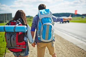 graphicstock-young-couple-of-travelers-with-rucksacks-hitch-hiking-by-road_B7VQ0_wfEW_thumb.jpg